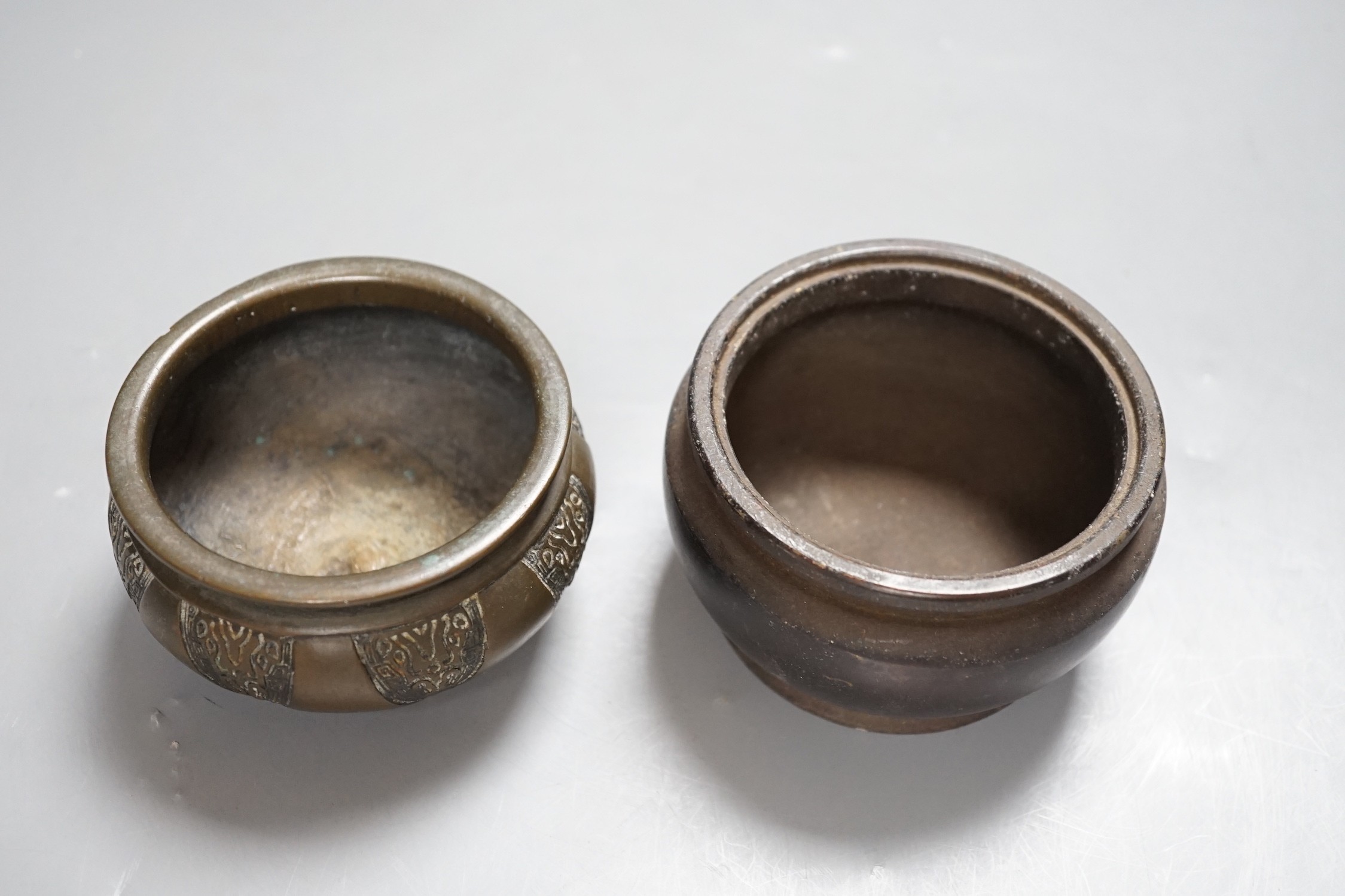 Two Chinese bronze censers, one inscribed, tallest 6cm